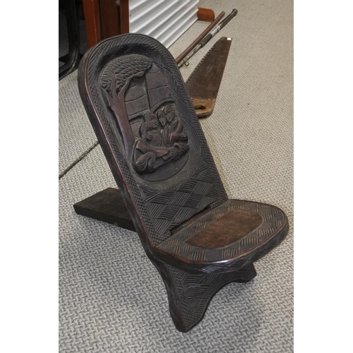 409 - A carved African tribal art folding stool.