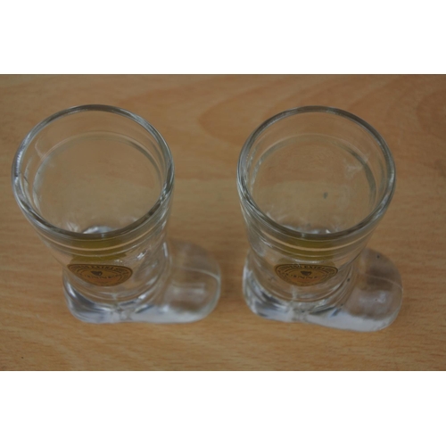 430 - A pair of Guinness glass boot measures.