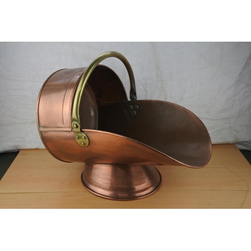 459 - An antique copper and brass coal scuttle.