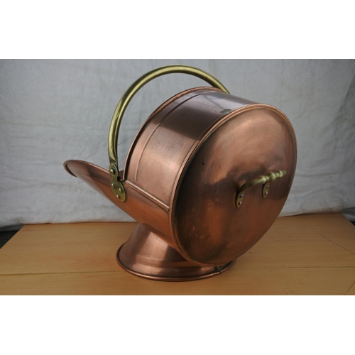 459 - An antique copper and brass coal scuttle.