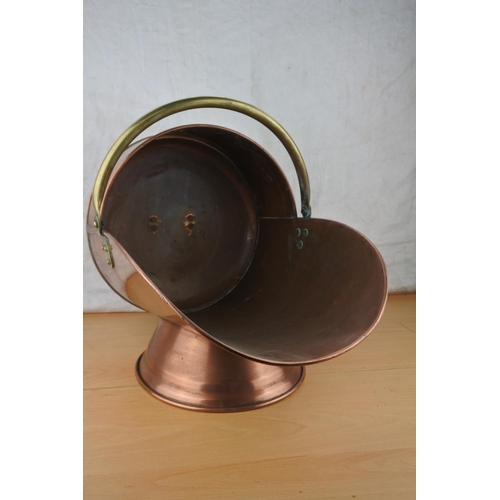 459 - An antique copper and brass coal scuttle.