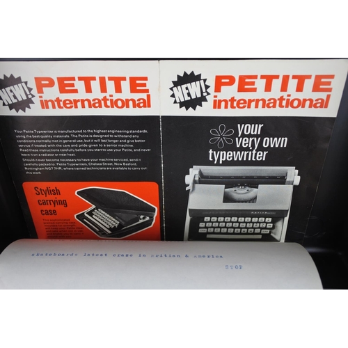 464 - A vintage cased Petite typewriter.