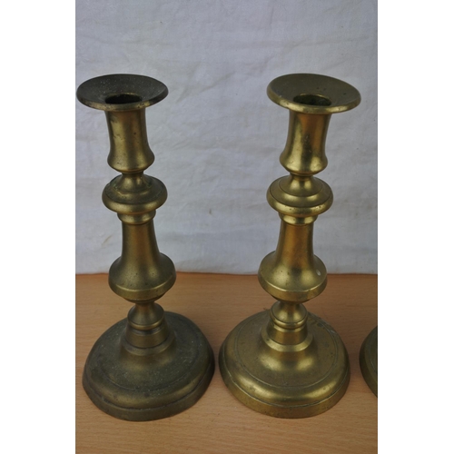 468 - Four brass candlesticks.