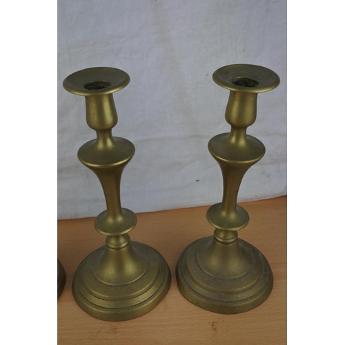 468 - Four brass candlesticks.