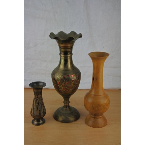 472 - A hand turned wooden vase and two others.