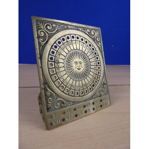 513 - A free standing brass sun dial and perpetual calendar.