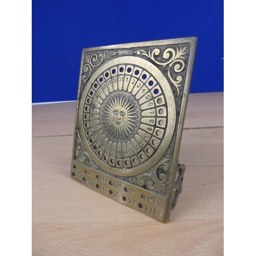 513 - A free standing brass sun dial and perpetual calendar.