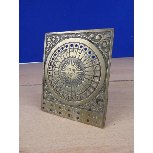 513 - A free standing brass sun dial and perpetual calendar.