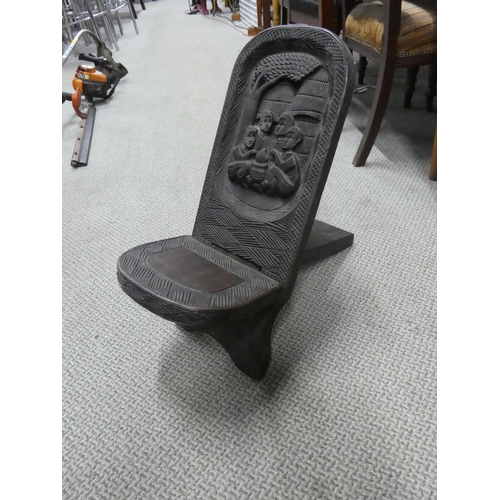 528 - A carved African tribal art folding stool.