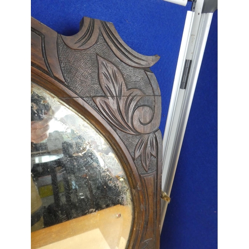 541 - A carved mahogany wall mirror.