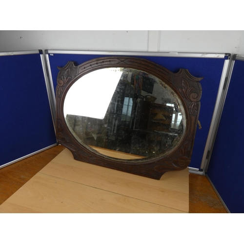 541 - A carved mahogany wall mirror.