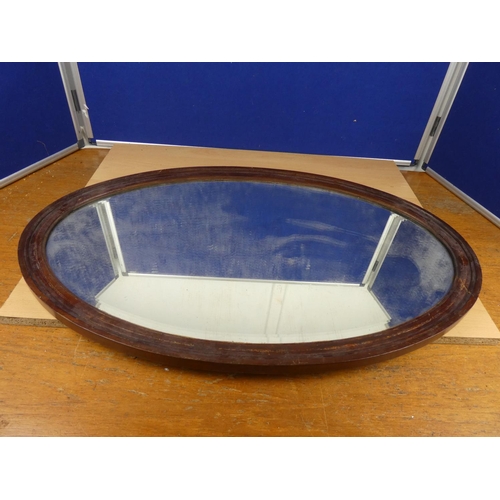 542 - An oval wall mirror.