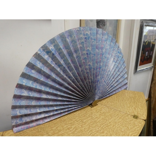 550 - A large paper fan on a brass fan.