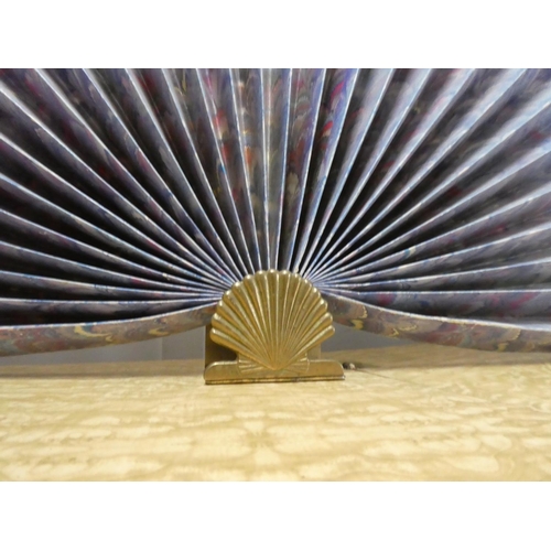 550 - A large paper fan on a brass fan.