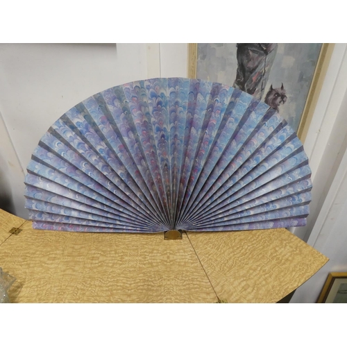 550 - A large paper fan on a brass fan.