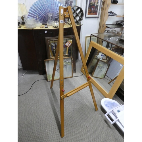 560 - A large wooden easel.