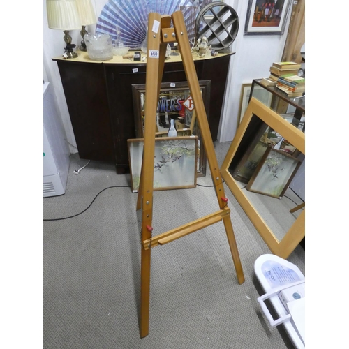 560 - A large wooden easel.