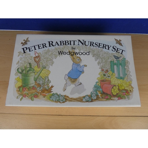 571 - A boxed Peter Rabbit nursery set.