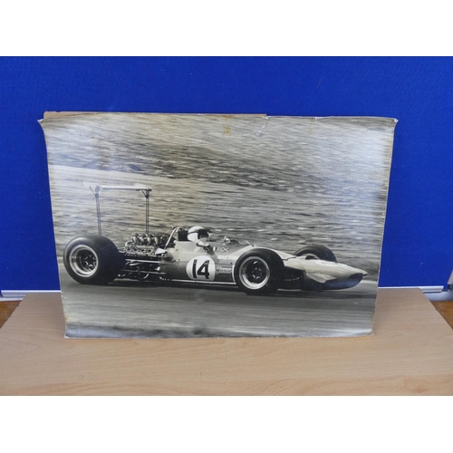 579 - A picture of Jackie Stewart racing car mounted on board.