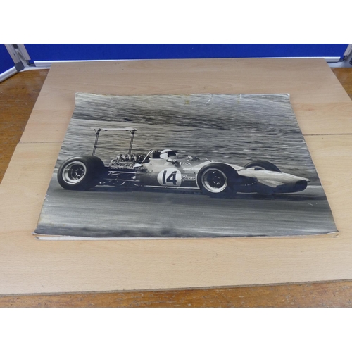 579 - A picture of Jackie Stewart racing car mounted on board.