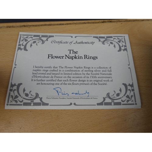 586 - A stunning boxed Franklin Mint set of 6 'Flower' napkin rings with certificate.