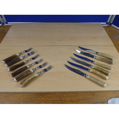 588 - A set of six bone handled knives and forks.