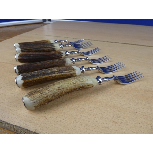 588 - A set of six bone handled knives and forks.