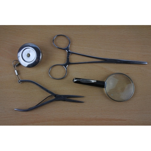 602 - A vintage leather cased Hockley & Abbey tape measure, a miniature magnifying glass and more.