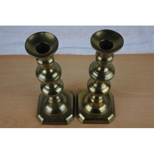 615 - A pair of brass candlesticks.