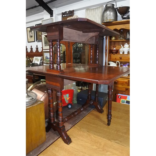 466 - An antique double sutherland table on casters.