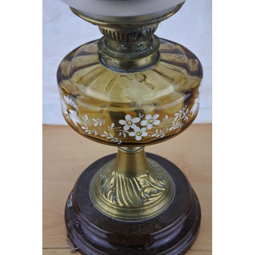 74 - A stunning antique oil lamp with hand painted tinted glass font. Approx 57cm.