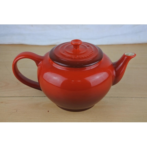 88 - A Le Creuset red teapot.