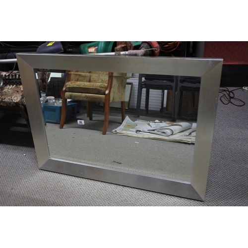 96 - A large modern silvered framed mirror. Approx 105x75cm.