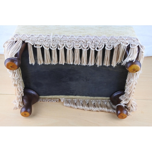 104 - A small upholstered footstool.