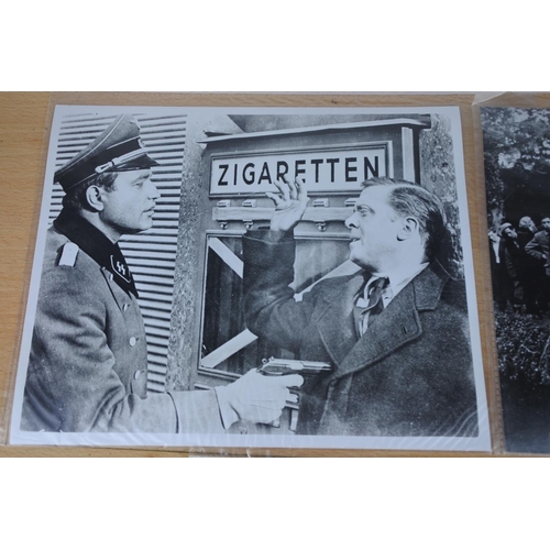 570 - An interesting lot of black and white movie stills photos including two featuring scenes from The Qu... 