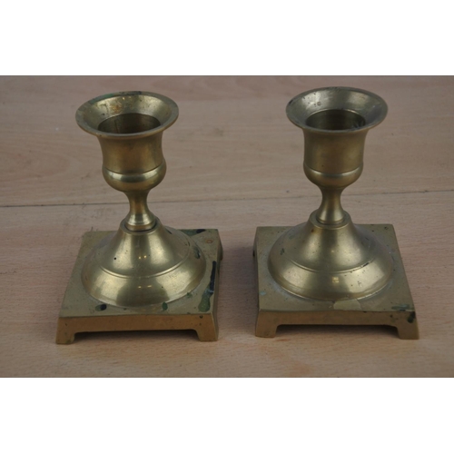 592 - A pair of brass candlesticks.