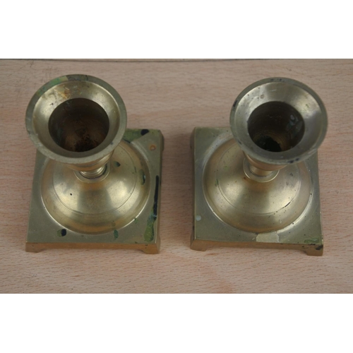 592 - A pair of brass candlesticks.