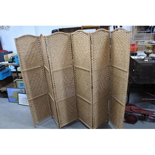 599 - A six fold rattan screen. Each panel approx 40x170cm.