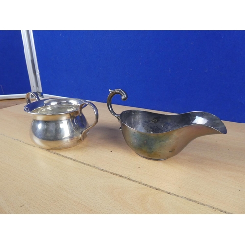 612 - A silver plated sauce boat and another.