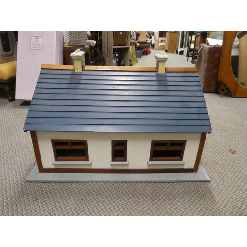 614 - A wooden dolls house. Approx 70x40x60cm.