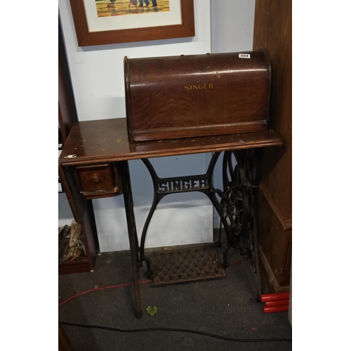 204 - An antique Singer sewing machine on original cast iron base. Approx - Base - 74x76xcm. Machine - 28x... 