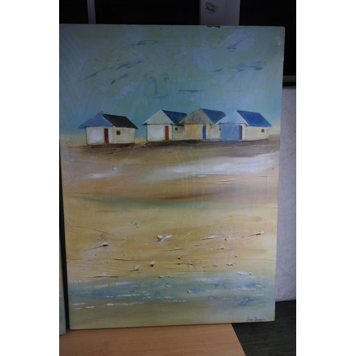 213 - A pair of beach scene pictures, each measuring 49cm x 69cm approximately.