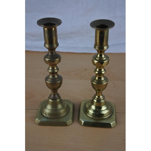 242 - A pair of brass candlesticks.