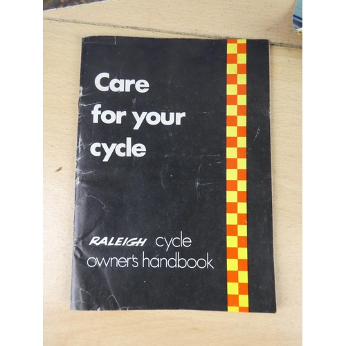 110 - Two vintage Raleigh posters and a Raleigh cycle handbook.