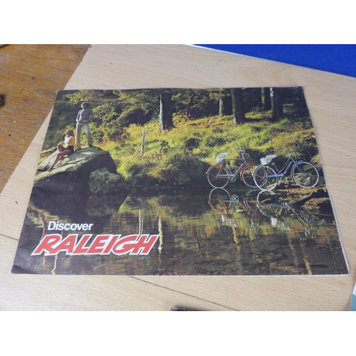 110 - Two vintage Raleigh posters and a Raleigh cycle handbook.