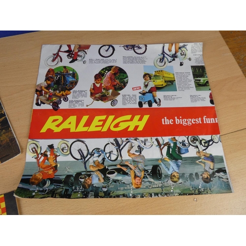 110 - Two vintage Raleigh posters and a Raleigh cycle handbook.