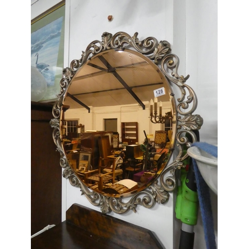 128 - A stunning tinted glass mirror, measuring 76cm in diameter.