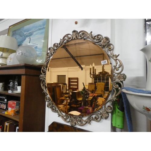 128 - A stunning tinted glass mirror, measuring 76cm in diameter.