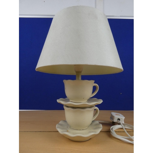 168 - An unusual pottery table lamp and shade, measuring 35cm in height.