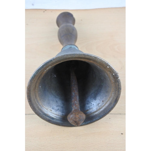 517 - An antique wood handled school bell.